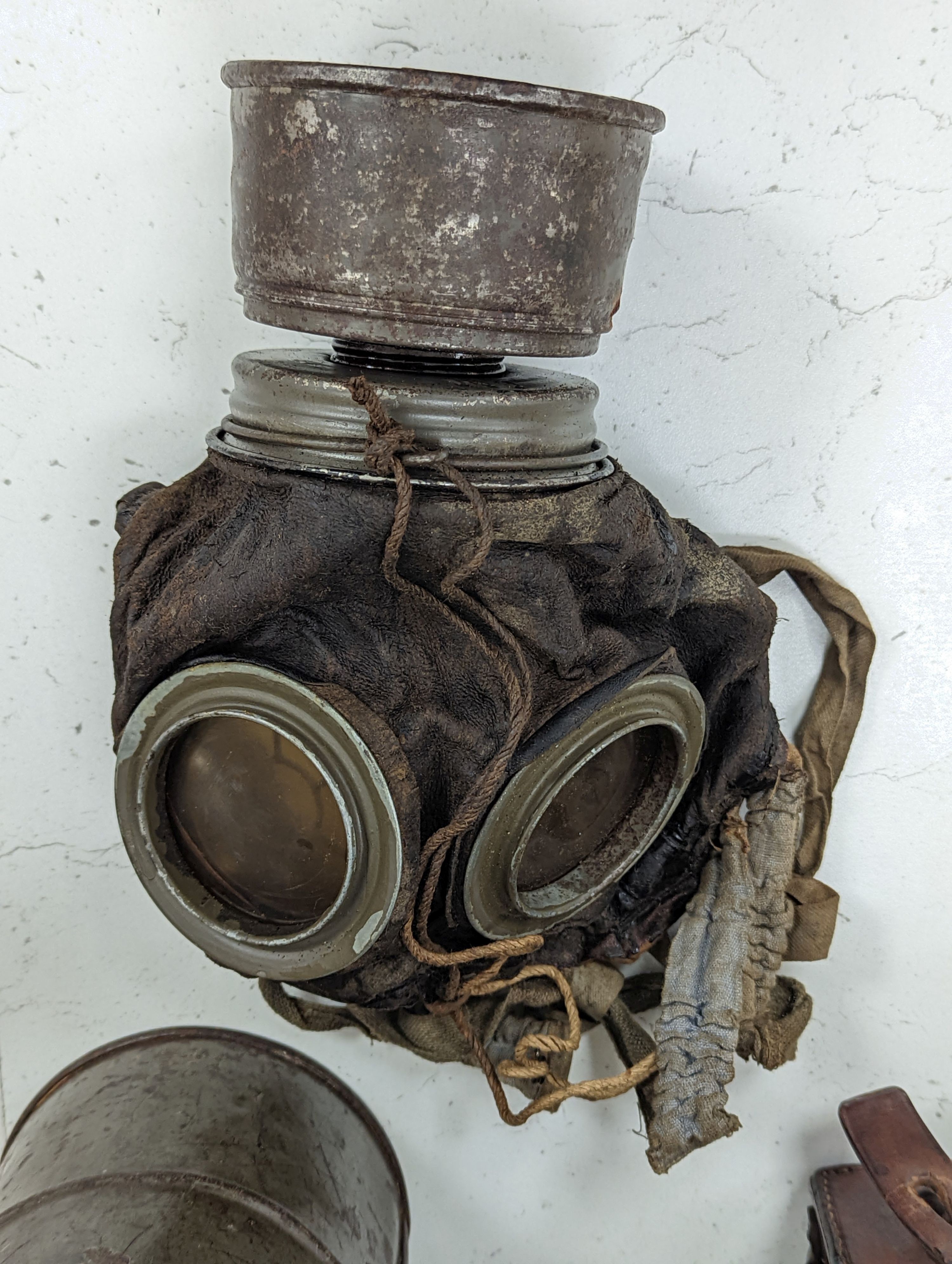 WWI German gas mask, two German trench mess tins and a German leather belt case